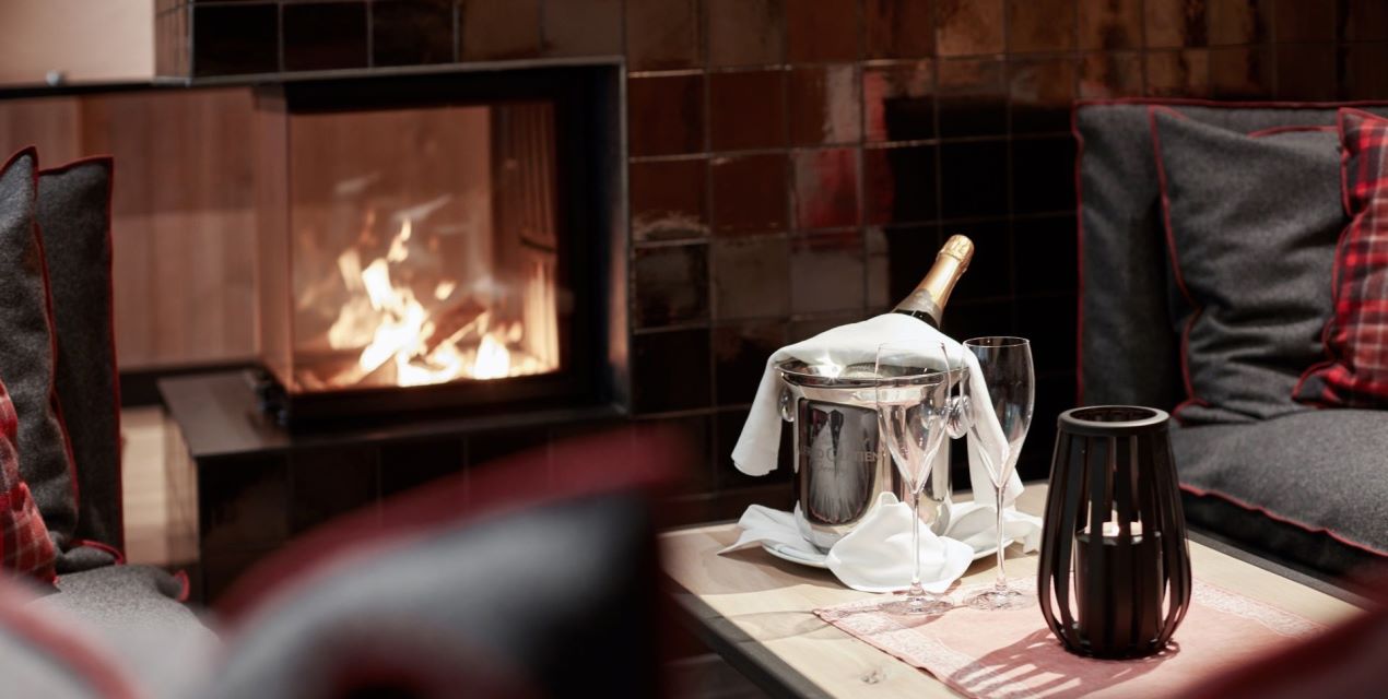 cosy open fire place with a bottle of champagne II